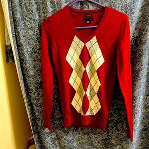 Red Charlie Brown style long sleeve light sweater.